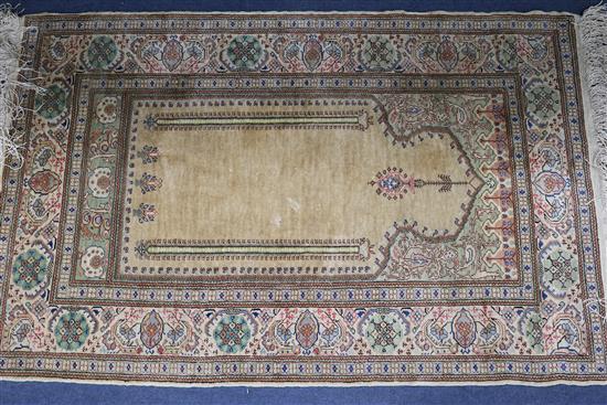 A cream ground Persian silk rug 113cm x 74cm